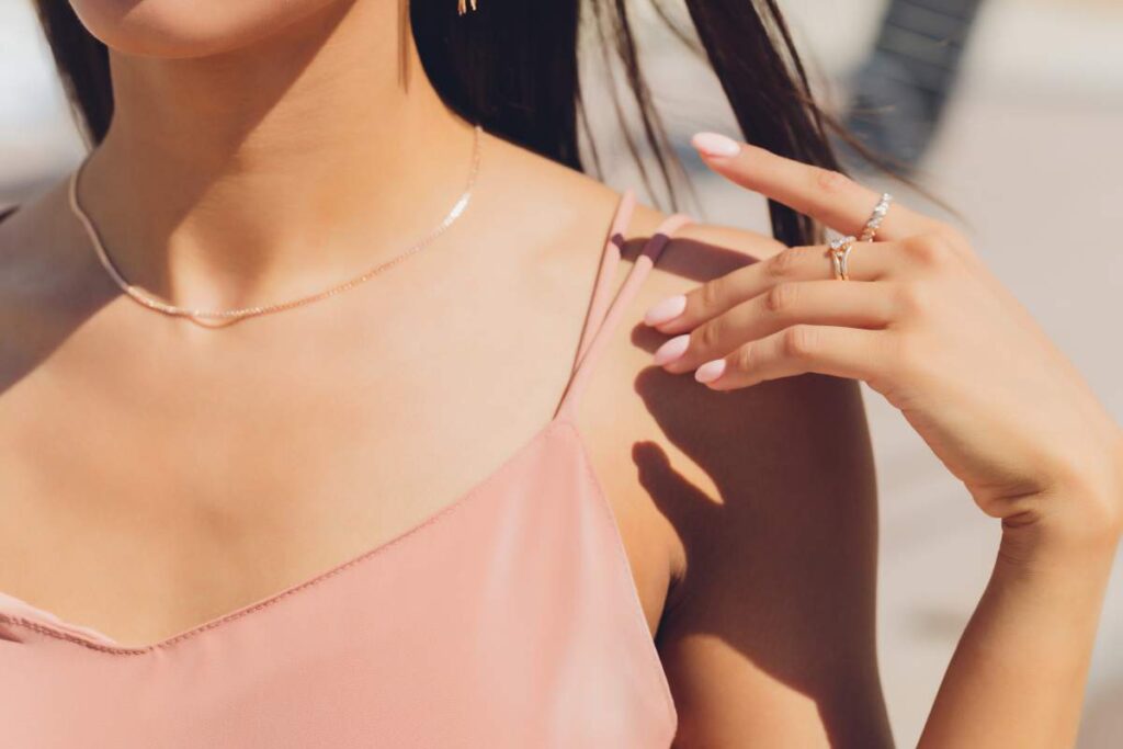 A close-up of several pearl necklaces and earrings on a soft cloth, showing natural shine and delicate surfaces.